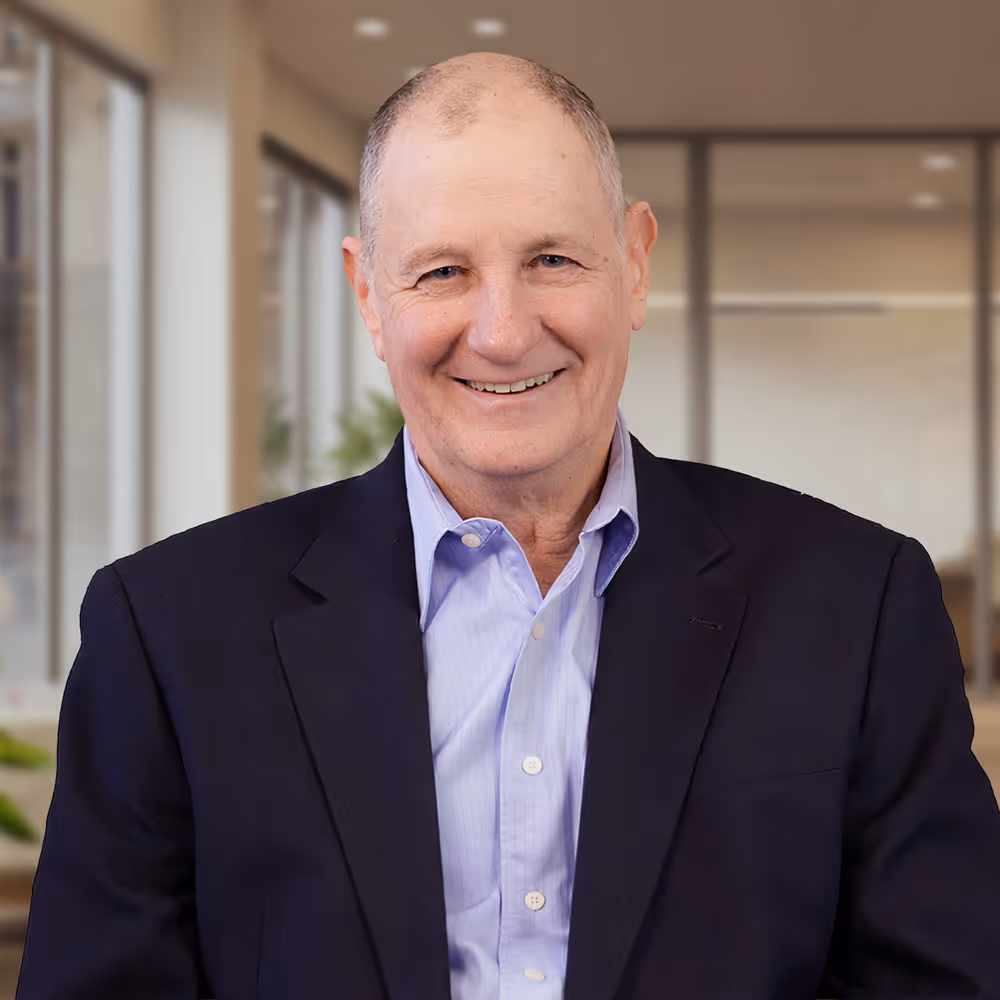 Bob Burakiewicz in a suit jacket and light blue shirt in an office setting.